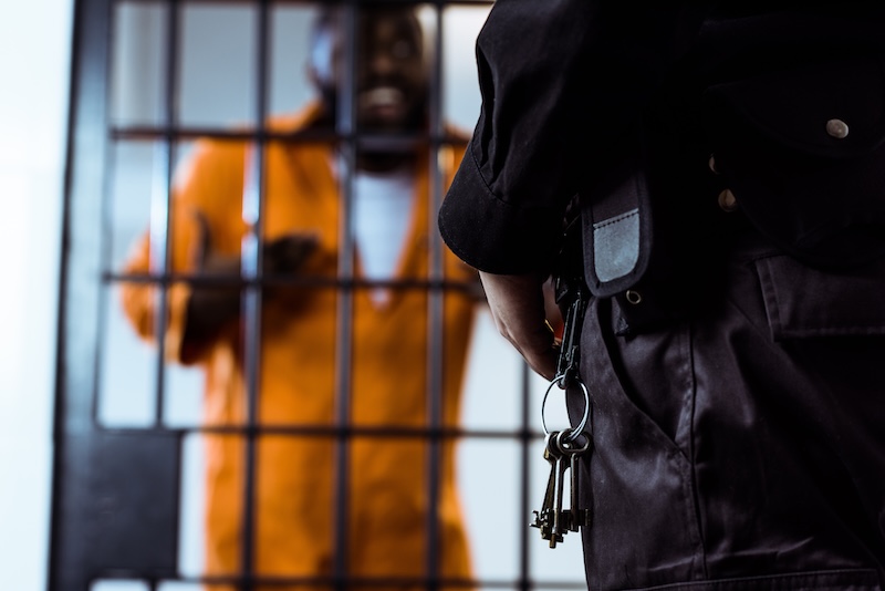 Cropped Image Of Security Guard Standing Near Prison Bars With Keys Correctional Guide App