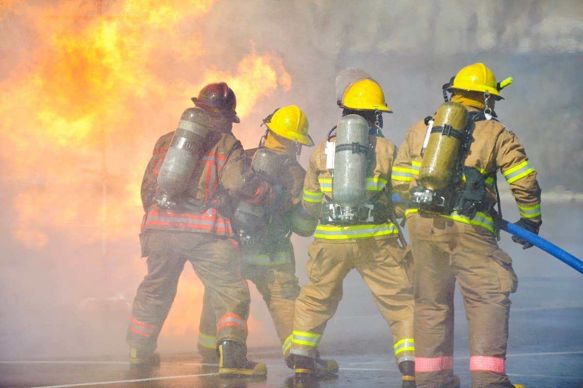 Group Of Firefighters Putting Fire Out Ptsd And Wellness App For Fire Fighters